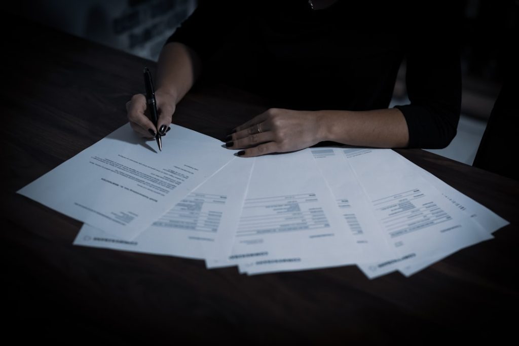 Business compliance documents being signed and reviewed